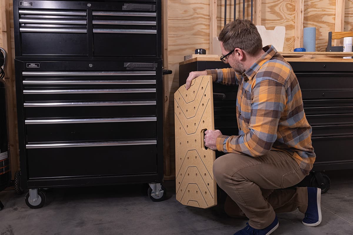 Image of a man removing a portable workspace from its hiding place